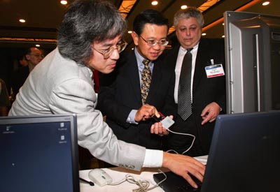 Mr. Wong (centre) examining technology uses ...
